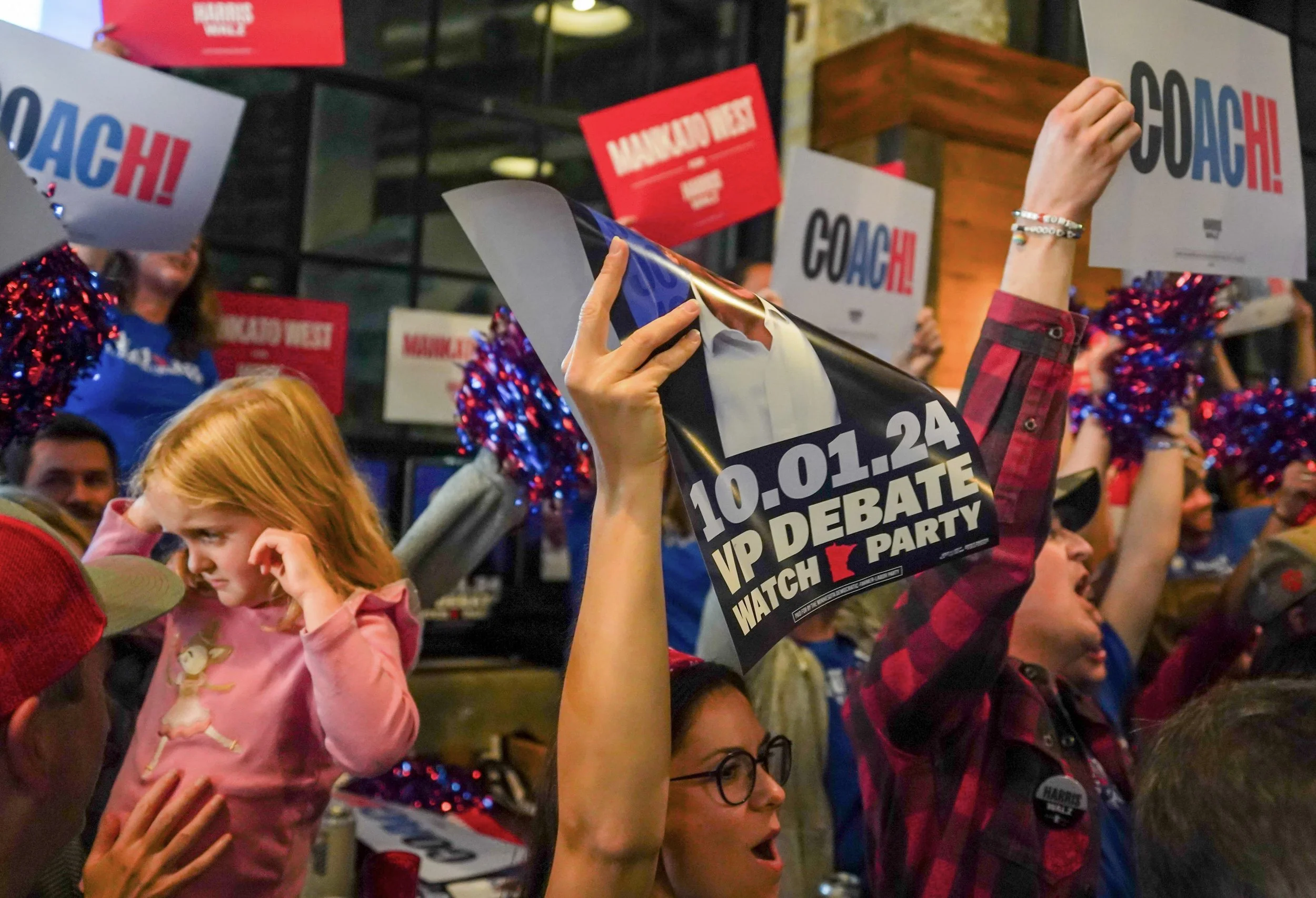 Former students of Mankato West High School gather to support Gov. Tim Walz during the DFL watch party at Dual Citizen Brewing Co. in St. Paul, Minn. on Tuesday, Oct. 1, 2024. (MPR News)