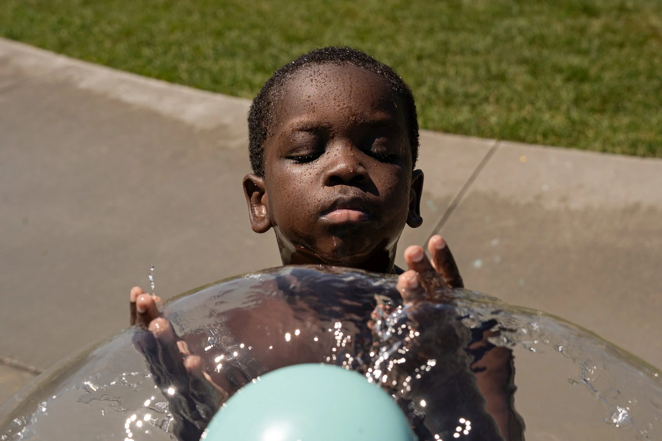 Emmanuel Ragwar, 5, cools off with some water Lincolnshire Splash Pad on Saturday, July 27, 2025 in Rochester. (Post Bulletin)