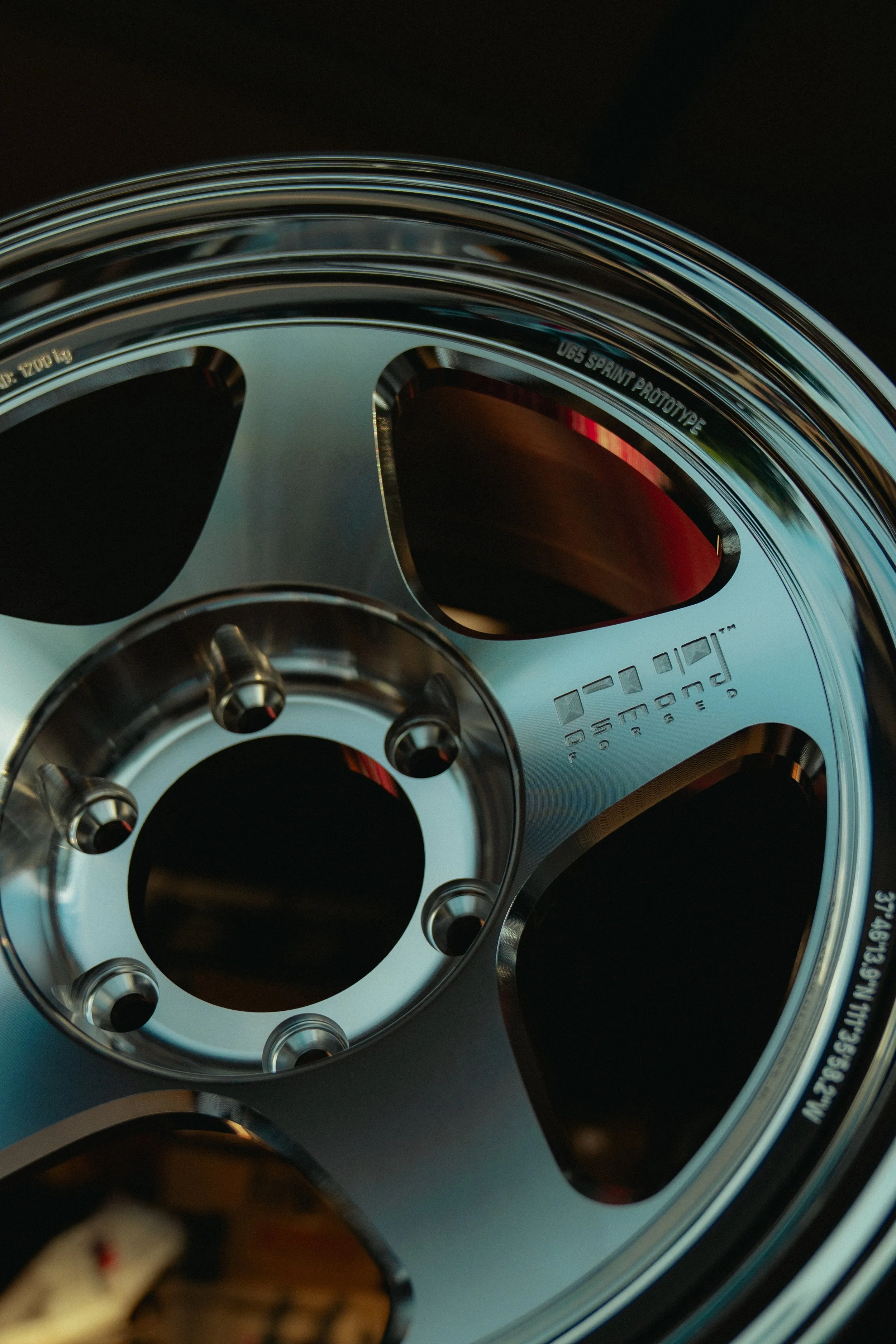 Close-up of a reel of 65 Sprint Prototype racing bicycle chainring with cutouts for weight reduction, made of metal with engraved text.