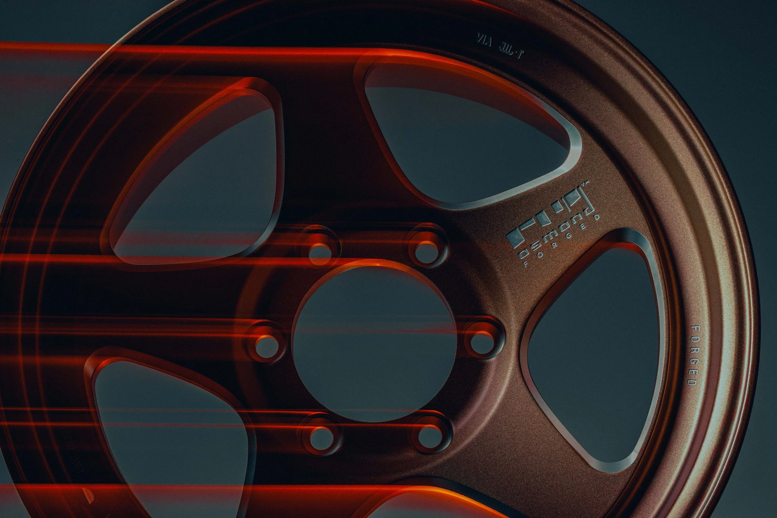 Close-up image of a bronze-colored wheel rim with some structural markings and a gradient background.