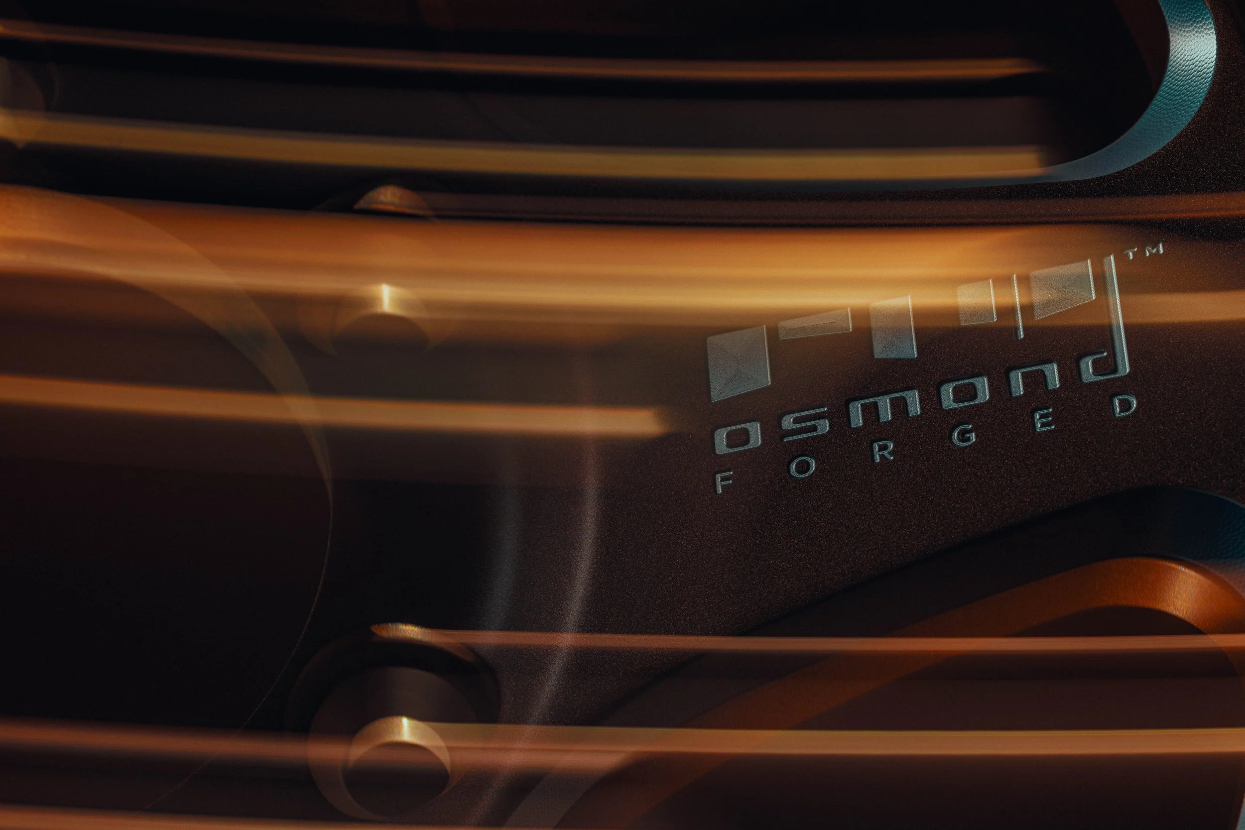 Close-up view of a black electronic device with the word 'POWERCYED' visible and colored lines or streaks across the surface.