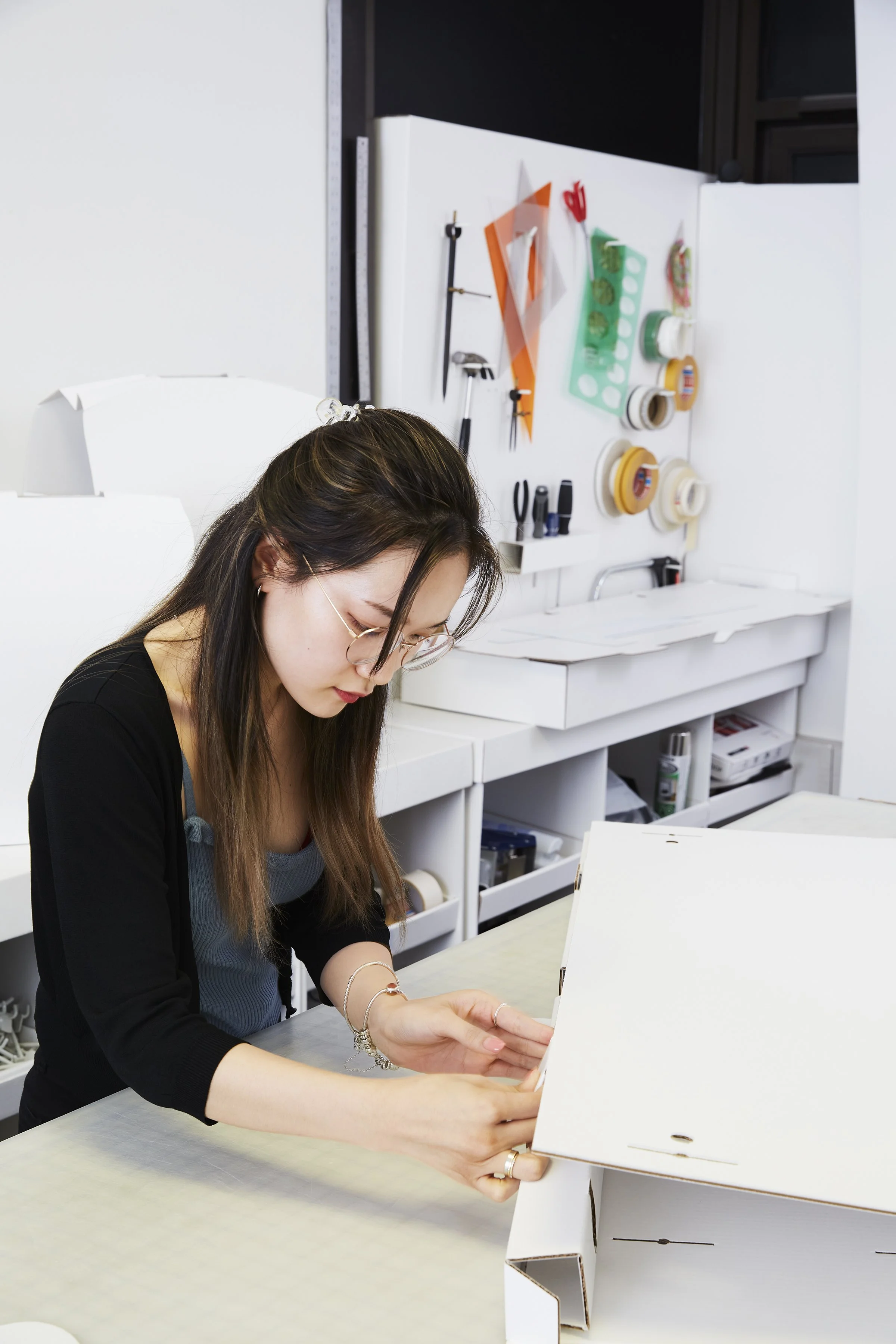 Proprint brand photography capturing a production team member carefully inspecting printed materials, highlighting the hands-on craftsmanship and attention to detail behind the company's work.