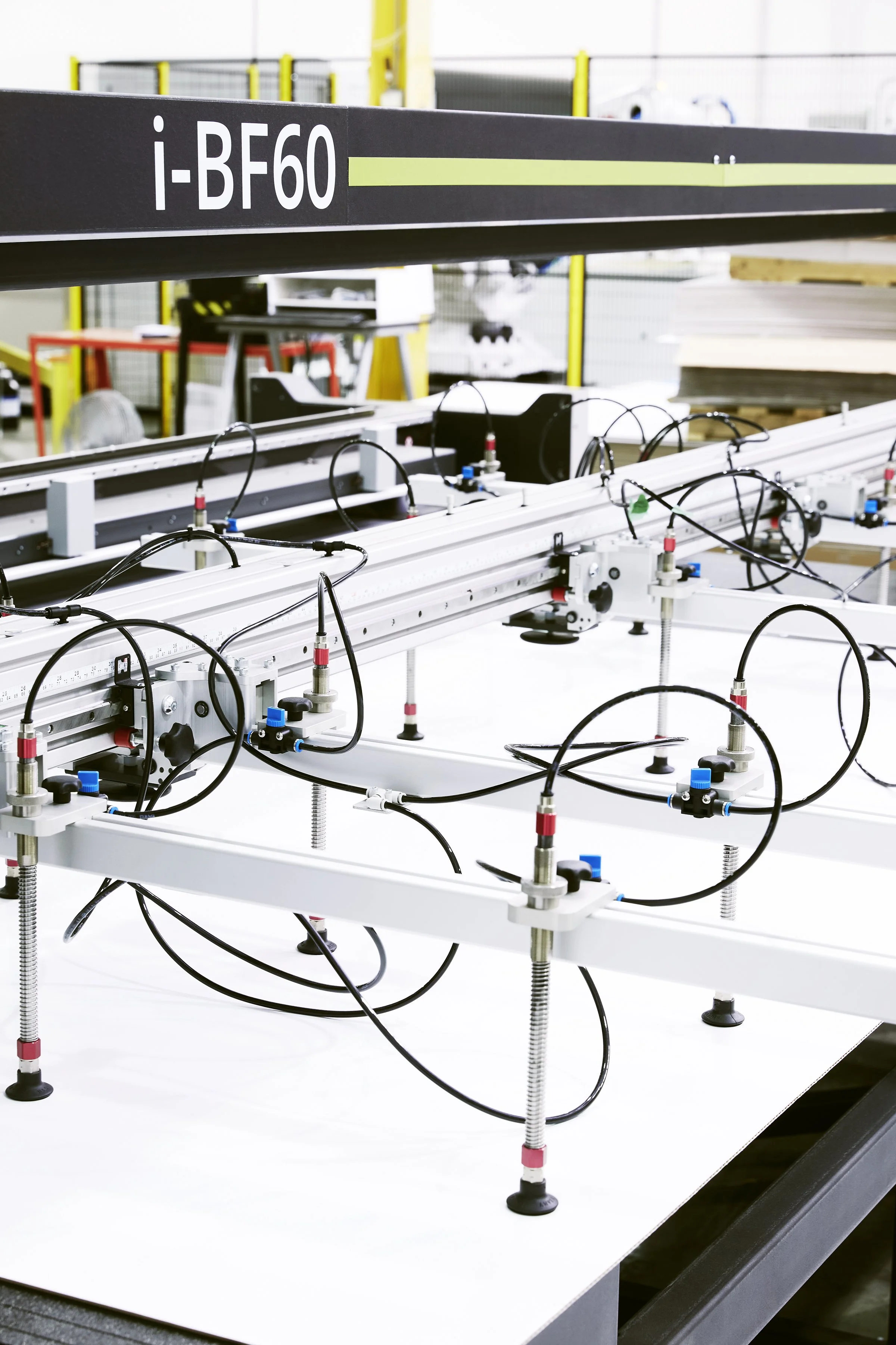 Industrial production equipment at Proprint's printing facility, featuring an automated system of pneumatic components, tubing and mechanical controls.