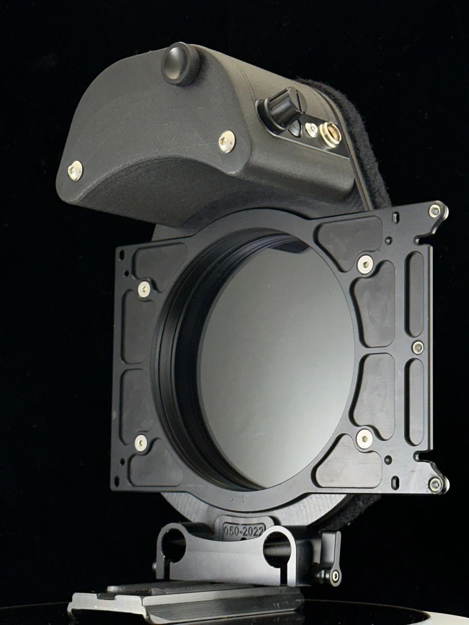 A camera lens mount attached to a camera body with a black background.