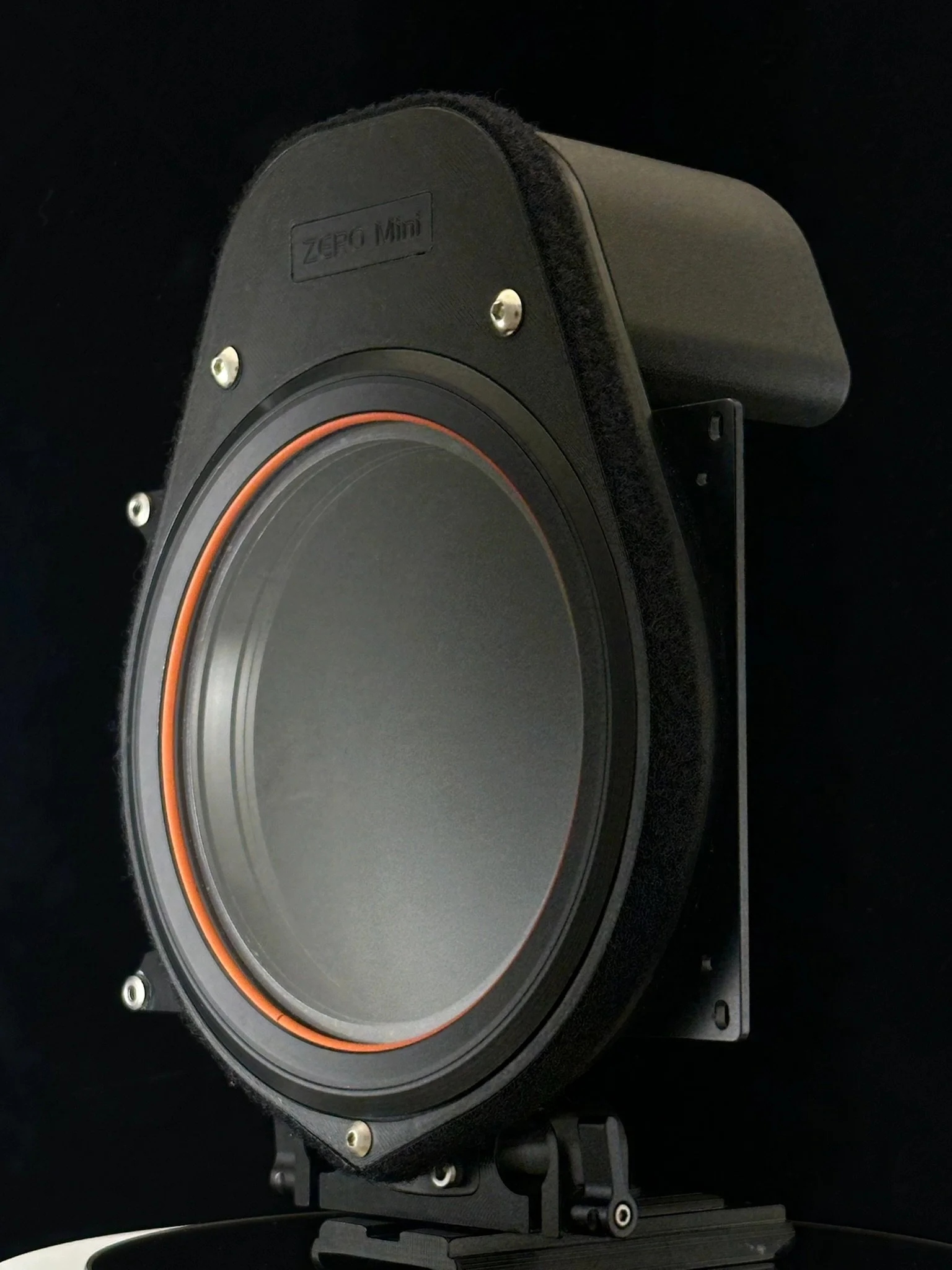 A large, professional-grade speaker with a black enclosure, mounted on a stand, branded 'ZERO Mini,' with a round speaker cone and orange accent ring.