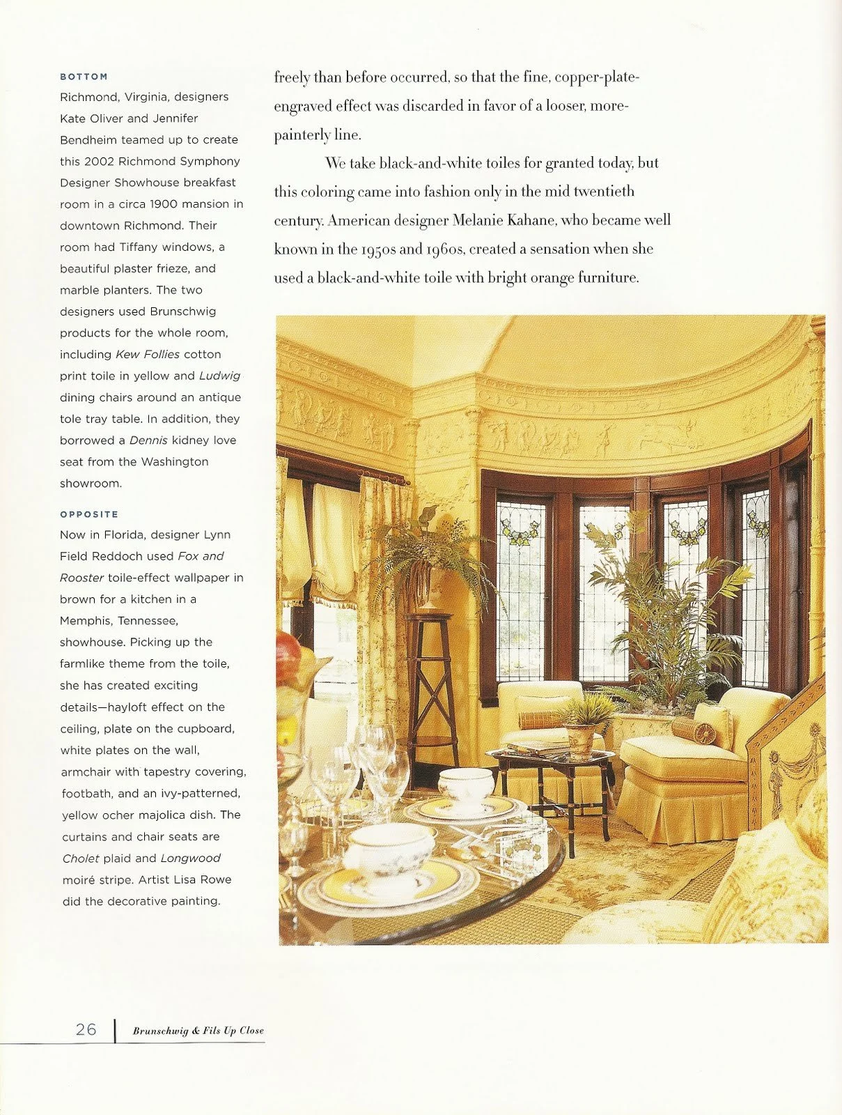 A brightly decorated living room with three large stained glass windows, yellow curtains, yellow walls, and ornate crown molding. There are various plants, a glass dining table set with dishes and wine glasses, a cushioned armchair, a small table, and decorative details throughout.