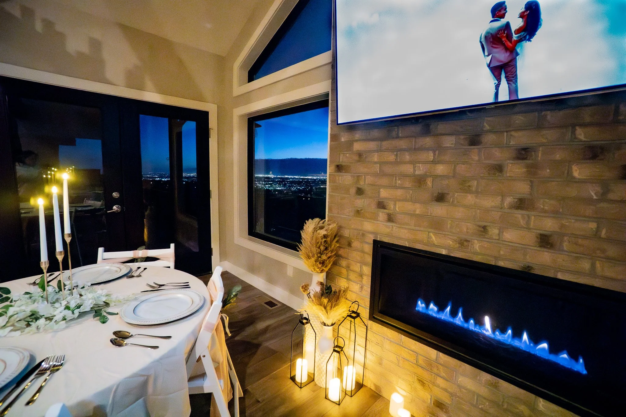 Formal seated dinner for a micro wedding at Denver Skyline Venue highlighting the stunning view, and fireplace.