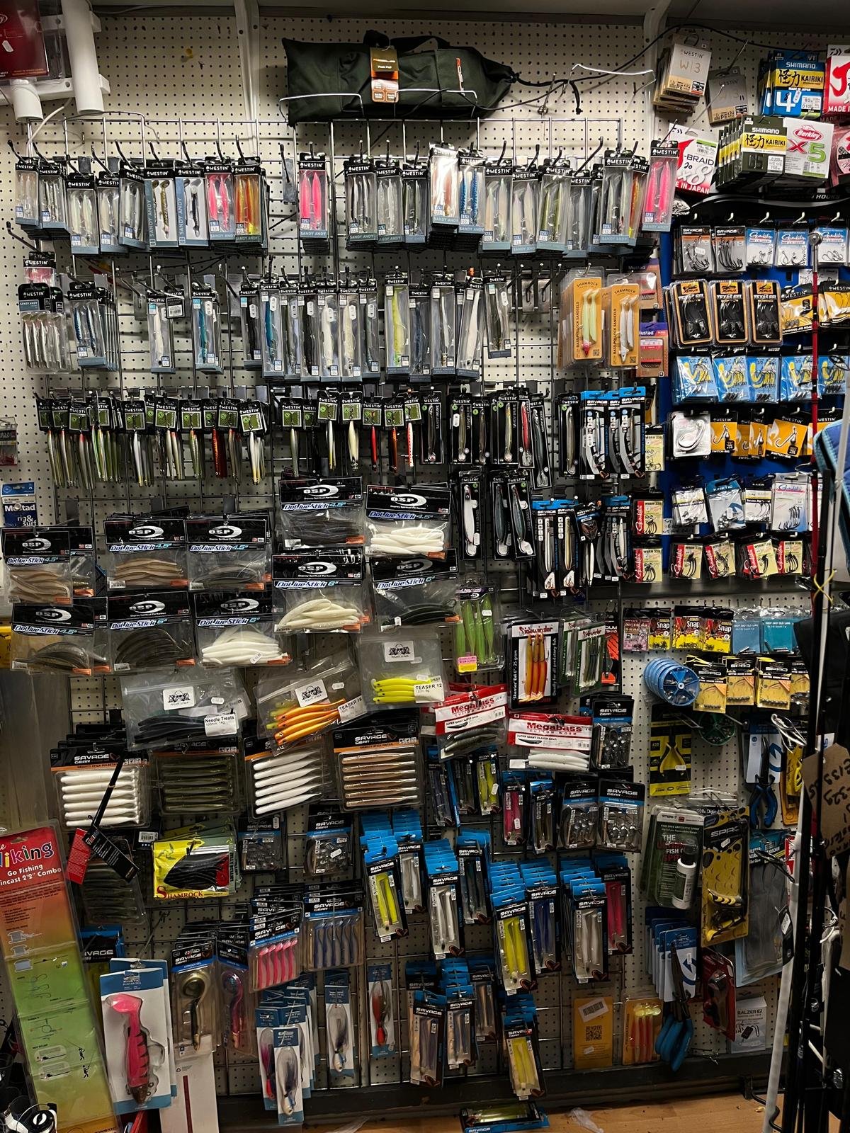 Large selection of hard lures and soft plastics displayed in an Irish tackle shop.