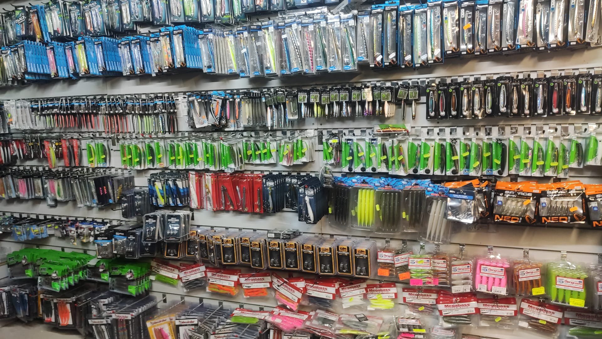 Wall of fishing lures displayed inside an Irish tackle shop.