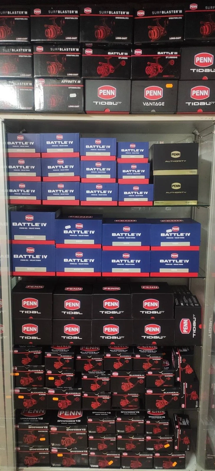 Fishing reels displayed on shelves inside an Irish tackle shop.