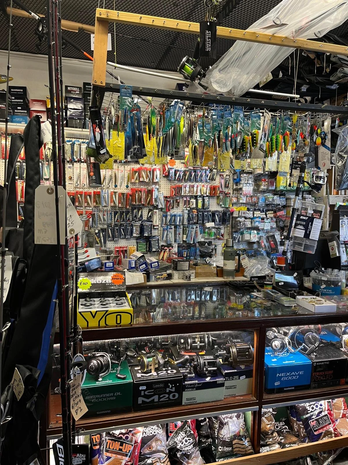 Interior of a traditional Irish tackle shop with fishing rods, reels, lures and terminal tackle on display.