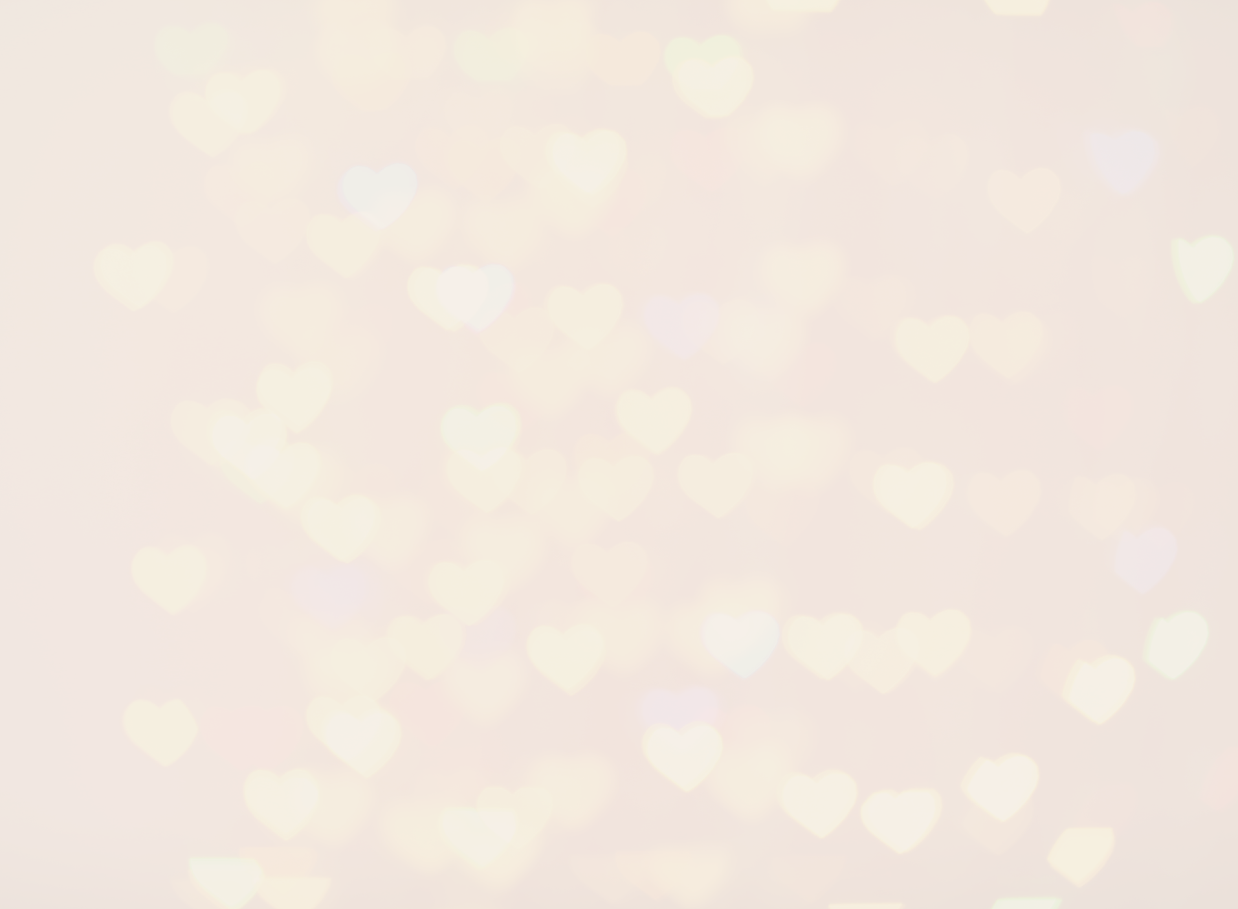 Blurry background with white and light yellow heart-shaped bokeh lights