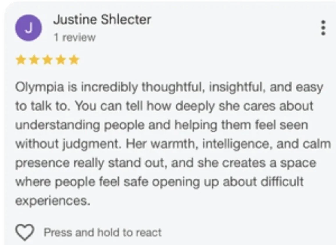 Google review by Justine Shlecter giving a 5-star rating, praising Olympia's thoughtful, insightful, and caring nature, highlighting her warmth, intelligence, and calming presence that creates a safe space for discussing difficult experiences.