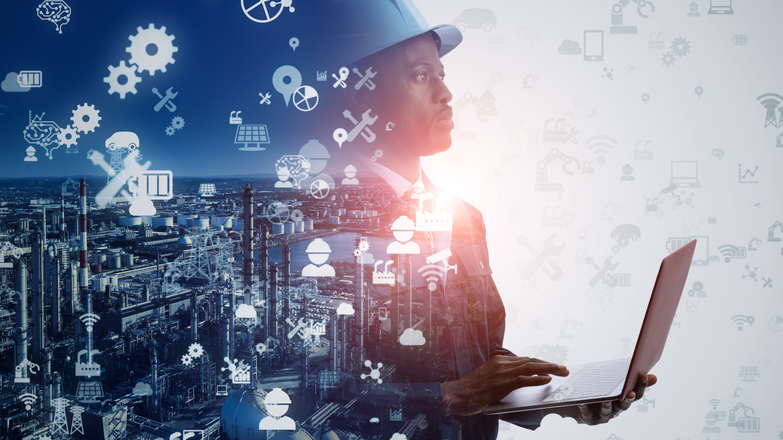 A woman wearing a safety helmet using a laptop with an industrial cityscape and digital icons overlaid, representing industry and technology.
