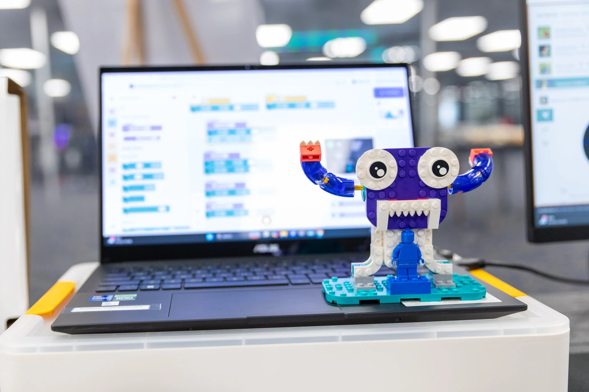 Student working at a computer programming AI