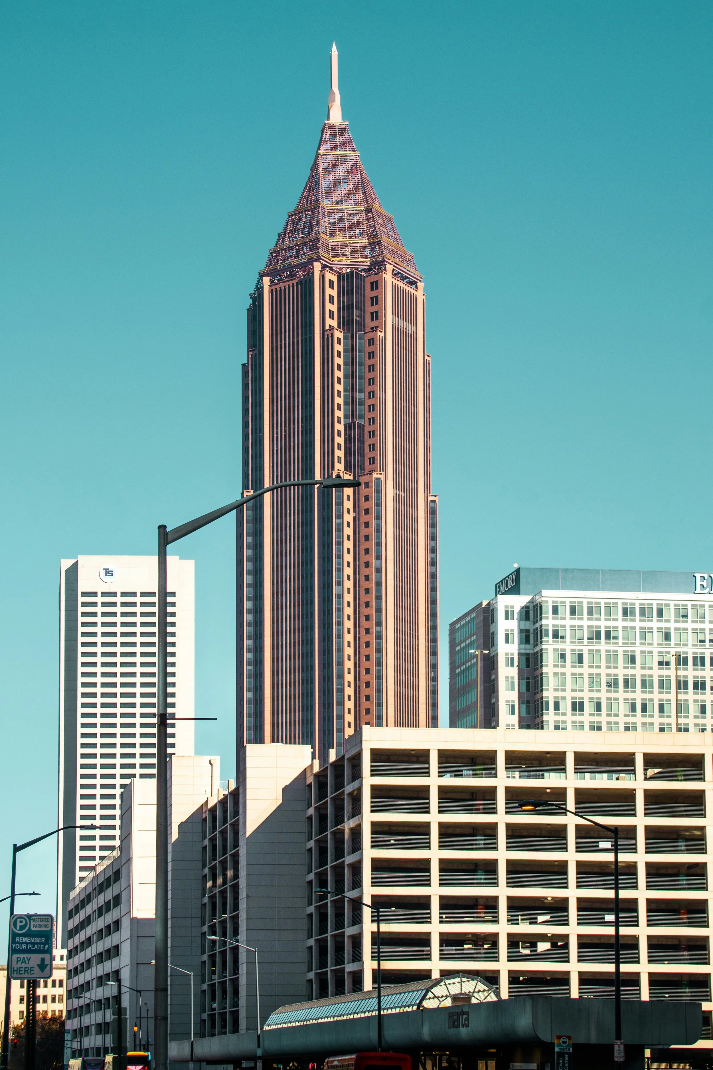 Skyline of downtown Atlanta featuring the tall, pointed Bank of America Plaza building, surrounded by other skyscrapers and city infrastructure.