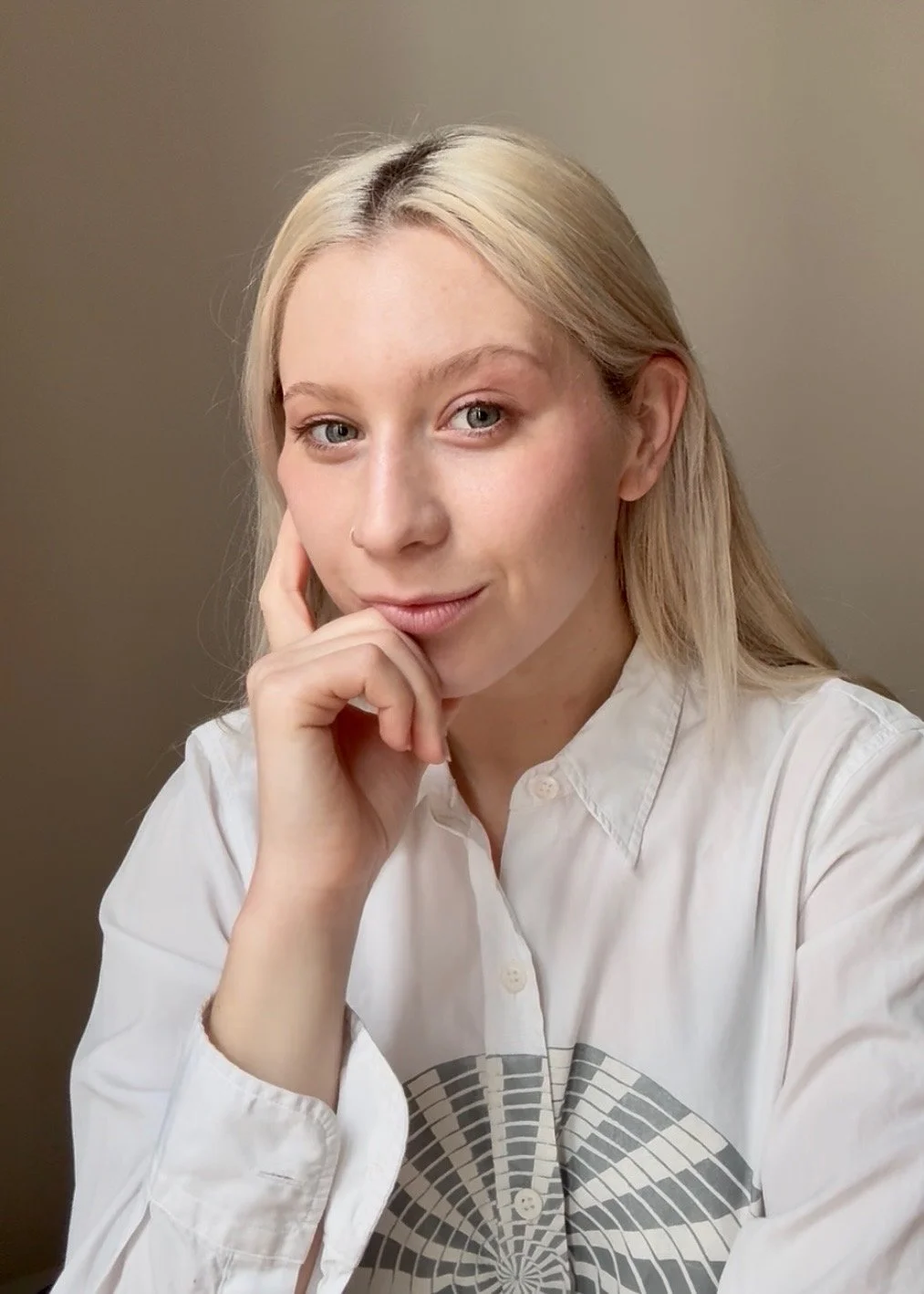 Portrait of a smiling woman, wearing a white button up shirt