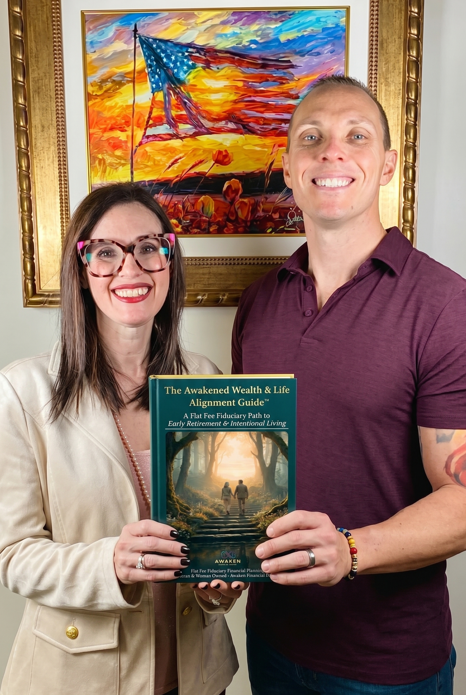 Two people smiling and holding a book titled 'The Awakened Wealth & Life Alignment Guide' in front of a colorful landscape painting that depicts a sunset and an American flag in a field of flowers.