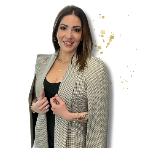 Young woman with dark hair, wearing a beige blazer over a black top, smiling, standing against a white background with gold paint splatters.