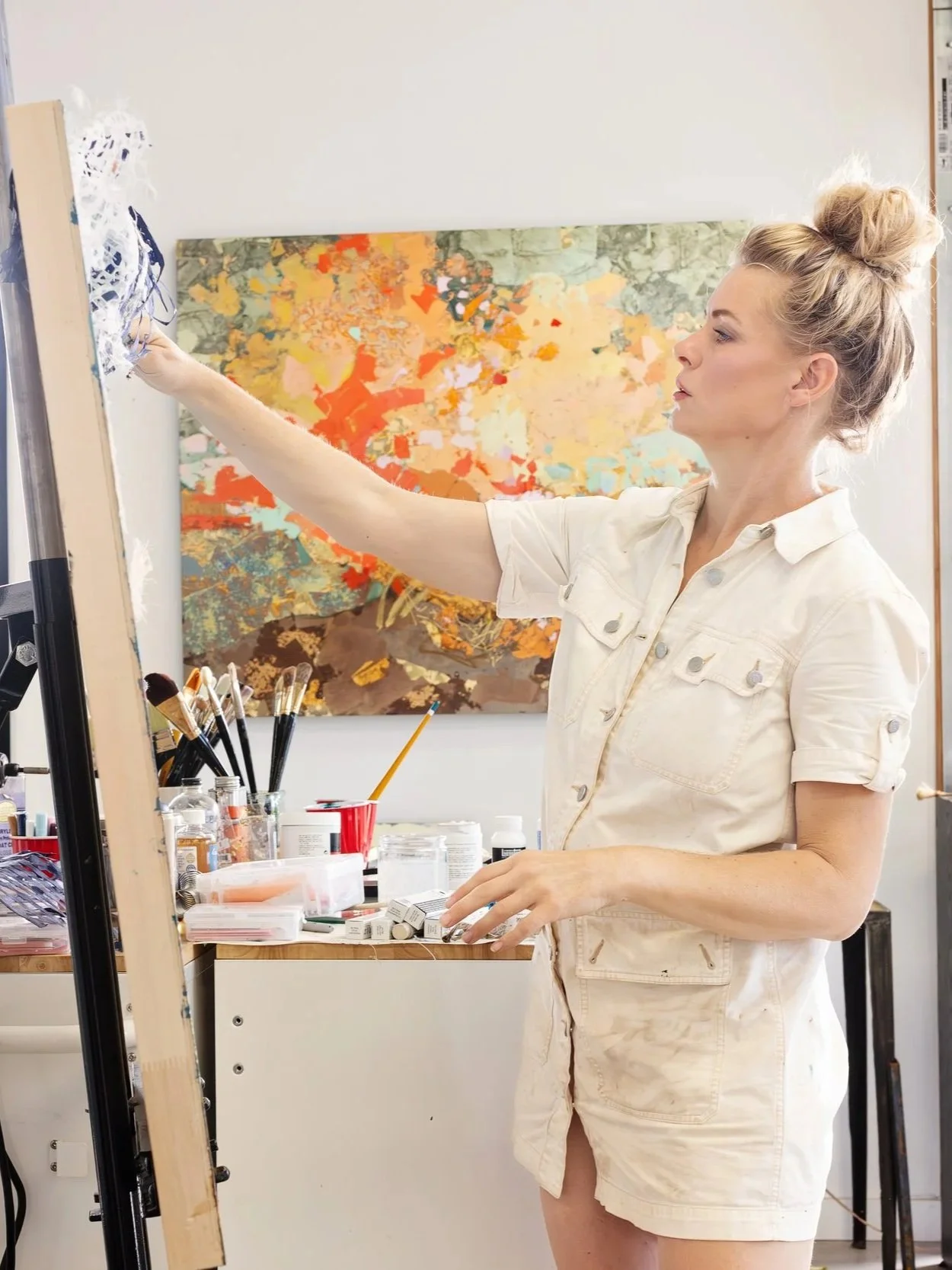 Elizabeth Page, fine art painter, working at the easel in her studio