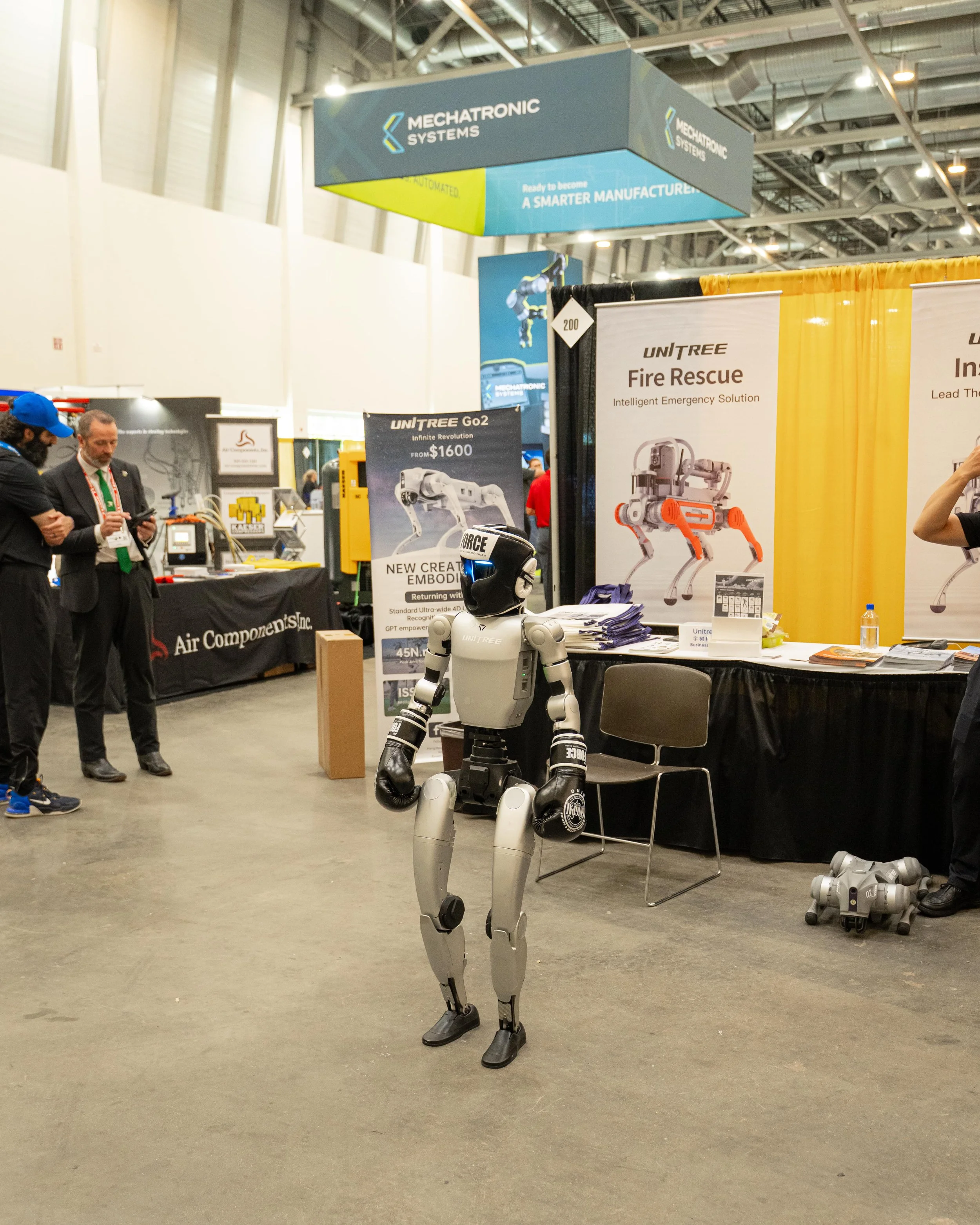 A humanoid robot standing in an exhibition booth at a trade show.