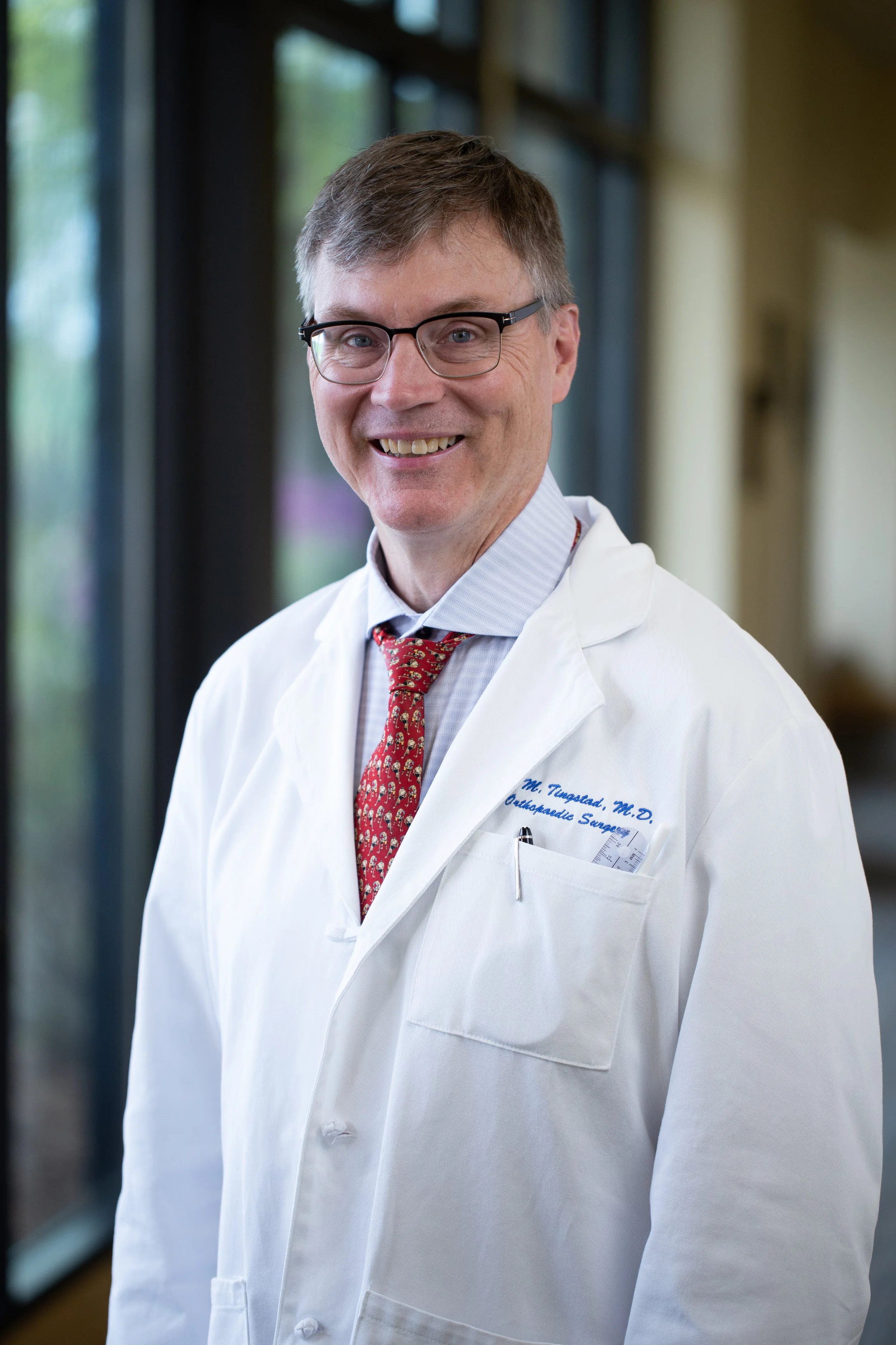 Dr. Ed Tingstad in white coat.