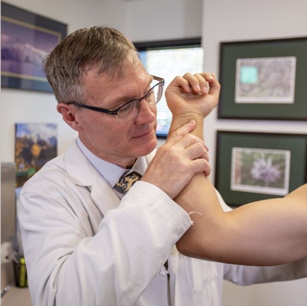 Dr. Tingstad performing a shoulder examination.