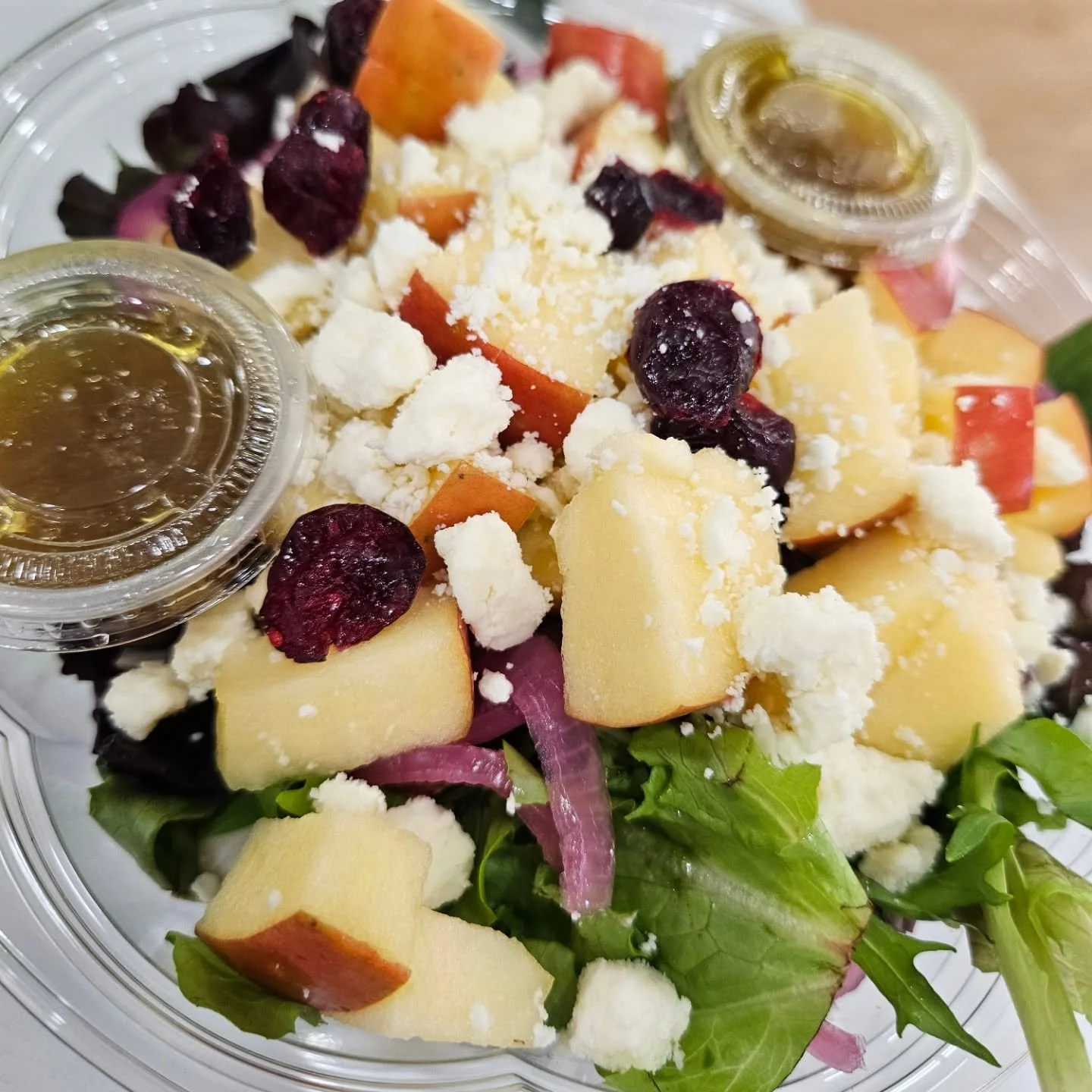 Our Apple Crunch Salad understood the assignment 🥬🍎 Sweet. Tangy. Crunchy. Crisp. It's balanced, bold &amp; fit to fuel you. Salad greens + crisp red apples + pickled red onions + almonds + craisins + feta + housemade honey dijon dressing = your ne
