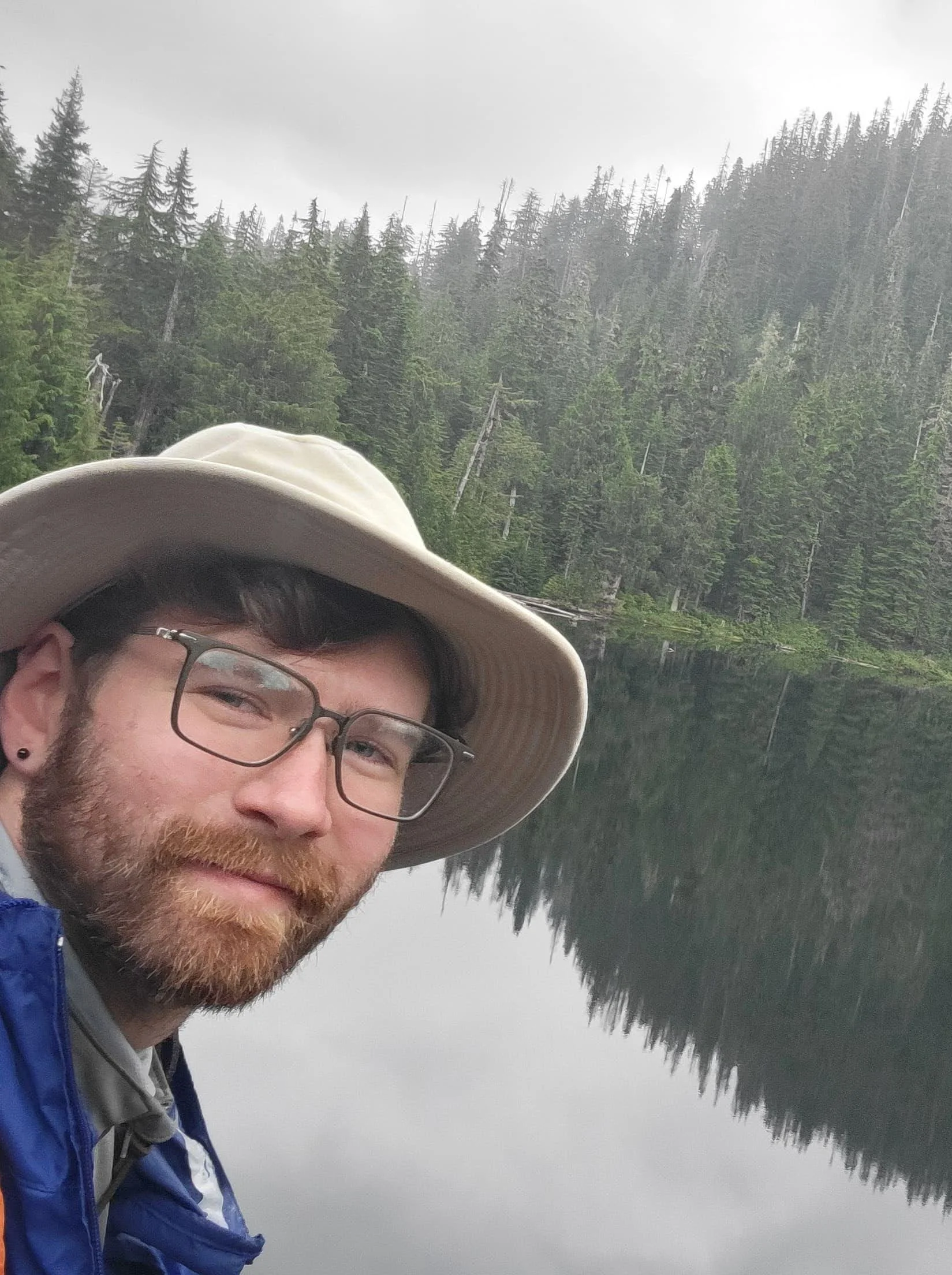 James near a lake, with a forest of evergreen trees. Surveys aquatic habitat, water quality, fish populations