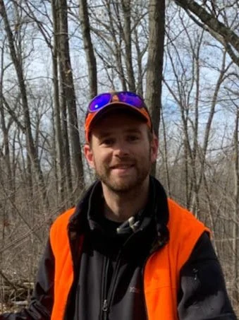 Josh conducting a field study in the forest. Habitat assessment, invasive species