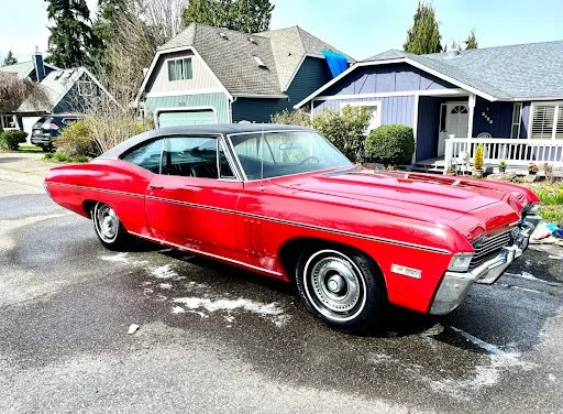 Classic red Impala detailed and polished in a customer driveway by Burdys Auto Detail