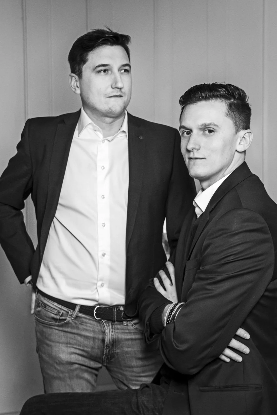 Deux hommes en costume posant pour une photo en noir et blanc