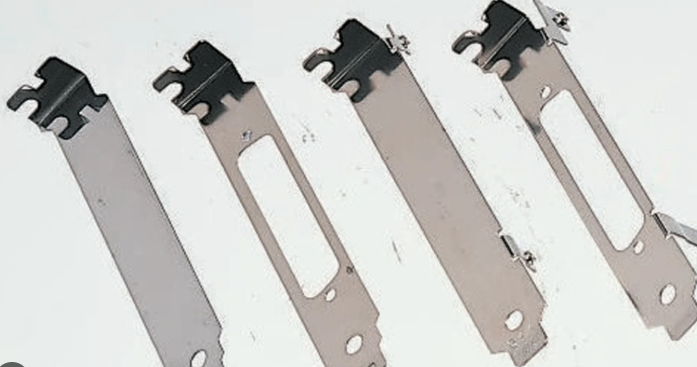 Four circular saw blades laid out on a white surface.