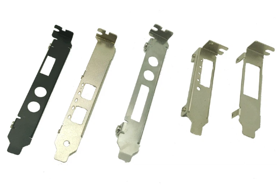 Five metallic computer hardware mounting brackets or chassis parts laid out in a row.