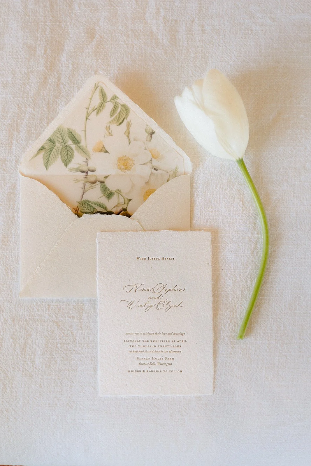 Cream toned handmade paper invitation with floral vellum liner