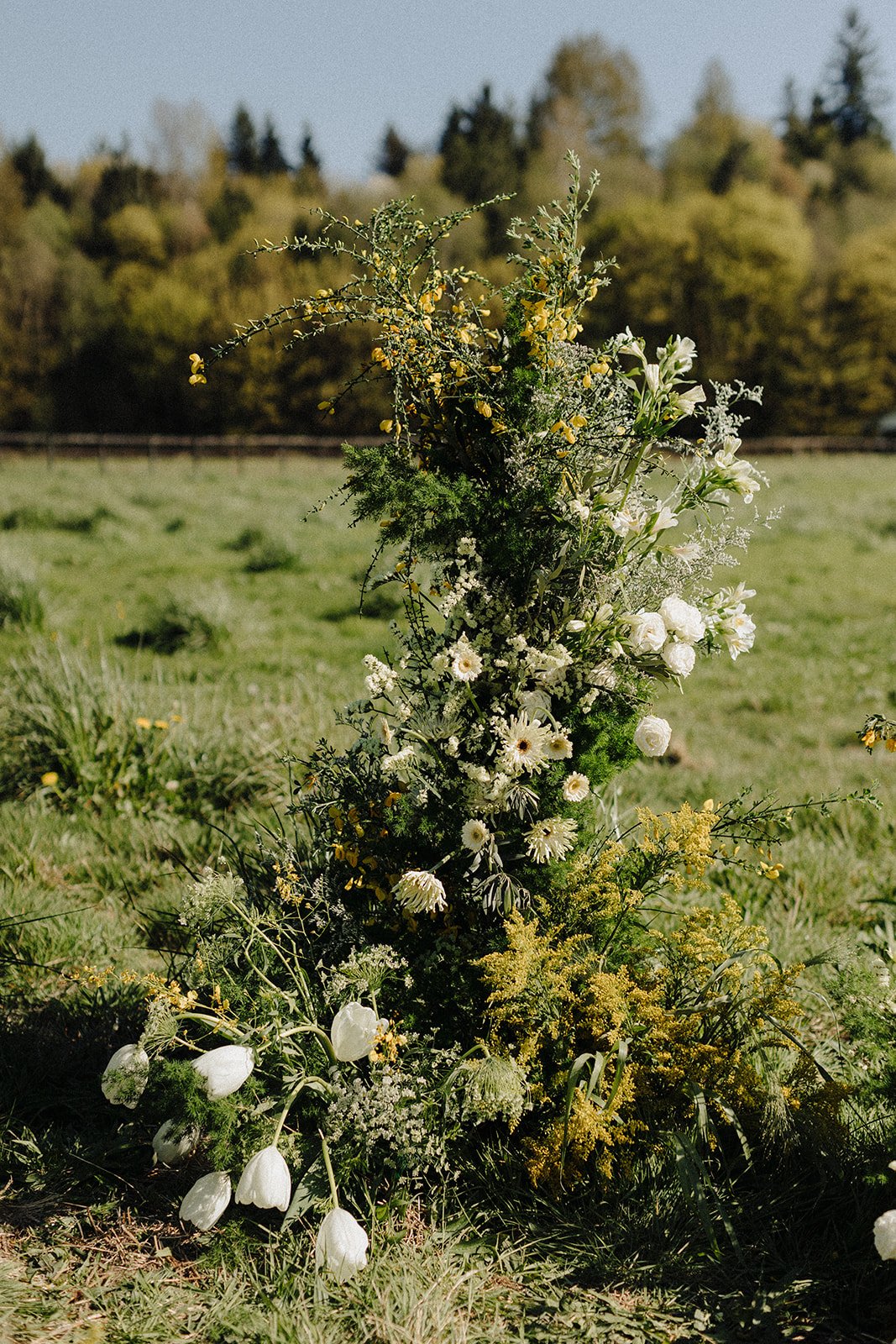 Wedding florals with white and yellow flowers and greenery
