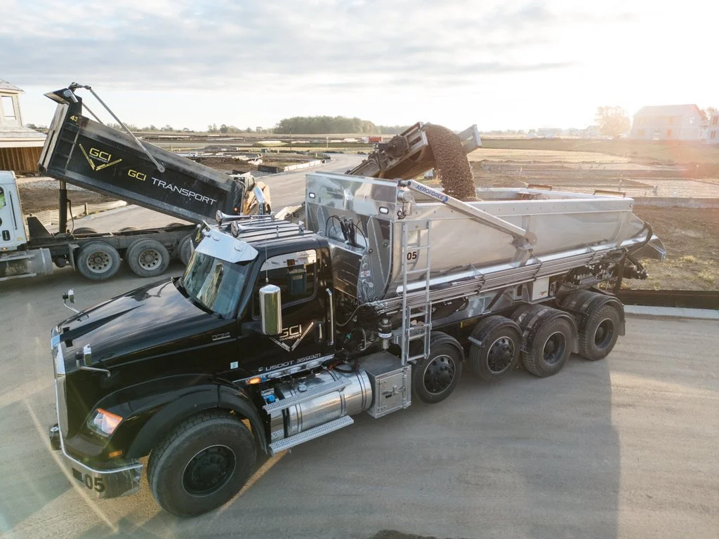 Material being poured into a GCI truck bed