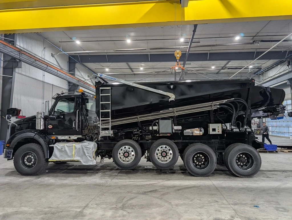 A black truck parked in the shop