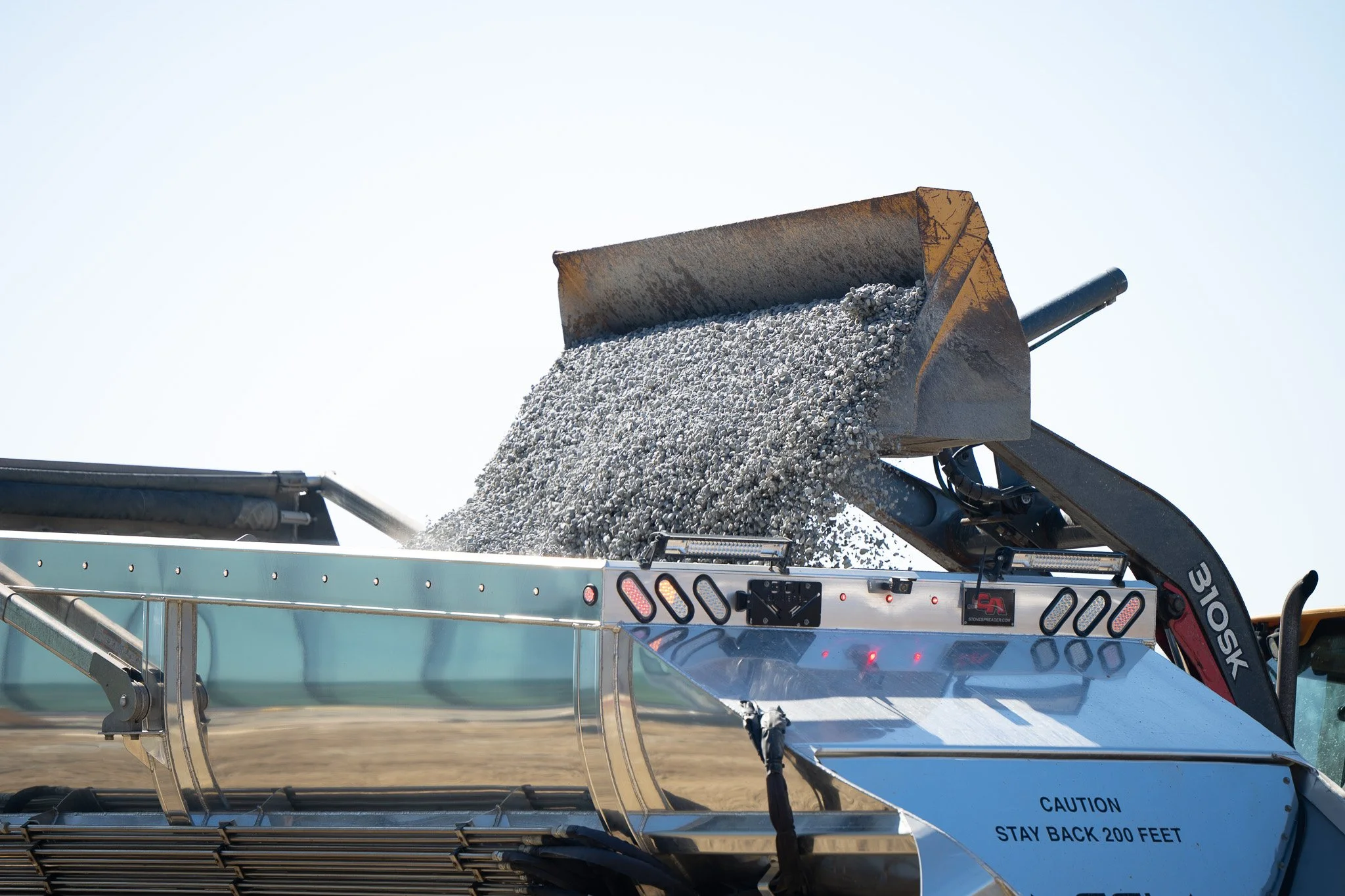 Gravel being poured into a truck bed