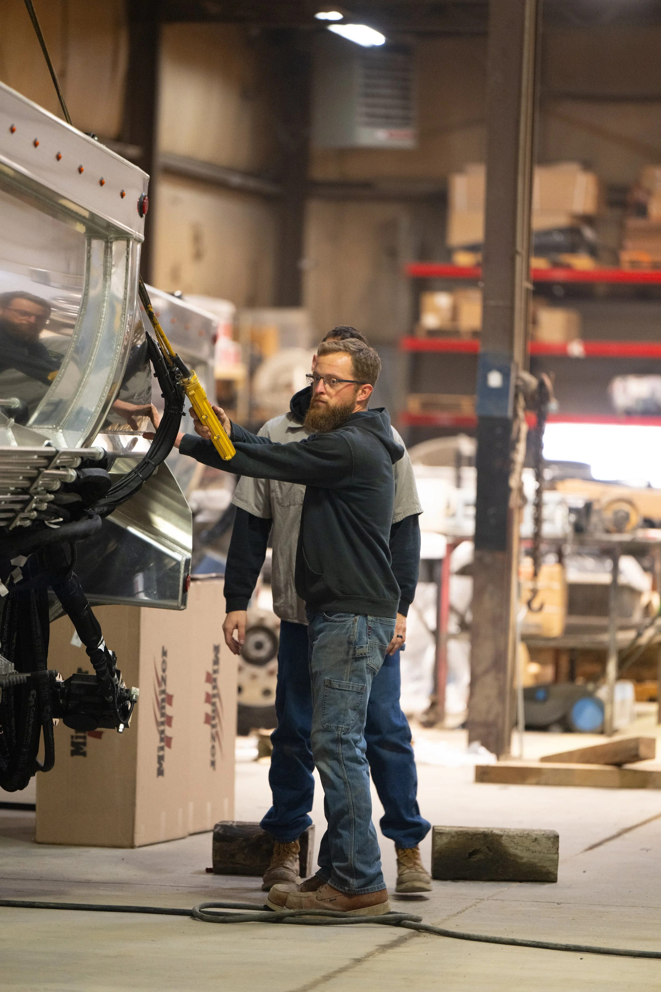 Two team members repairing a truck bed