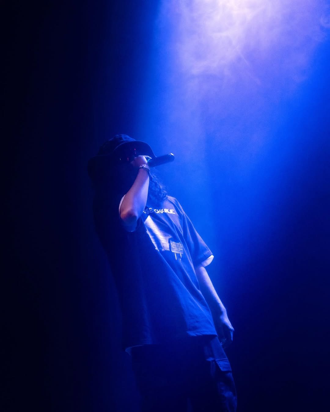 a Music artist Singing into a microphone