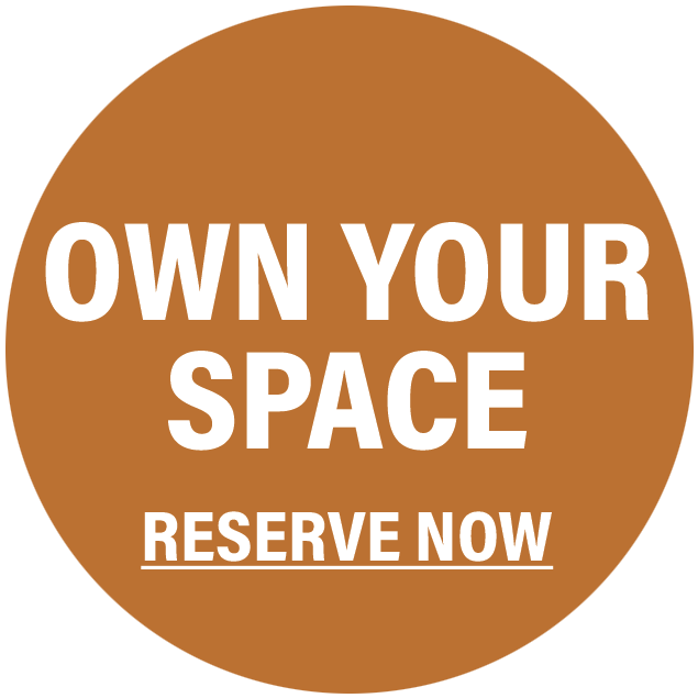 Circular brown sign with white text that says "OWN YOUR SPACE RESERVE NOW".