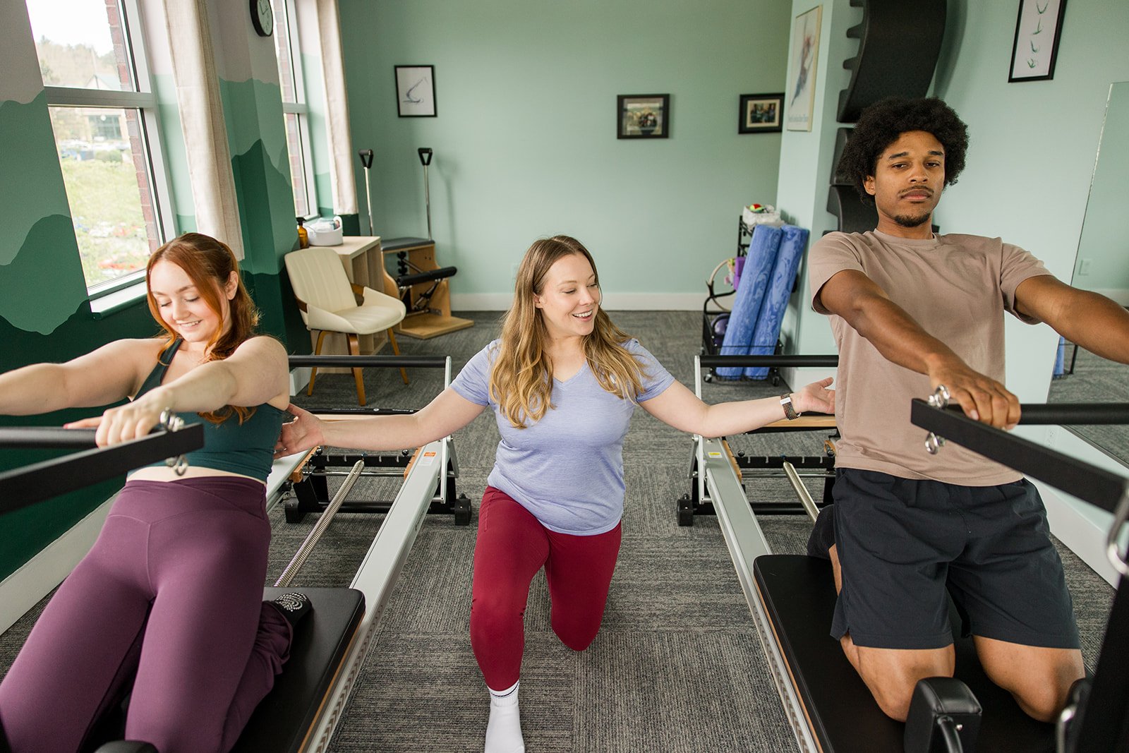 couple doing a pilates semiprivate session on the reformer