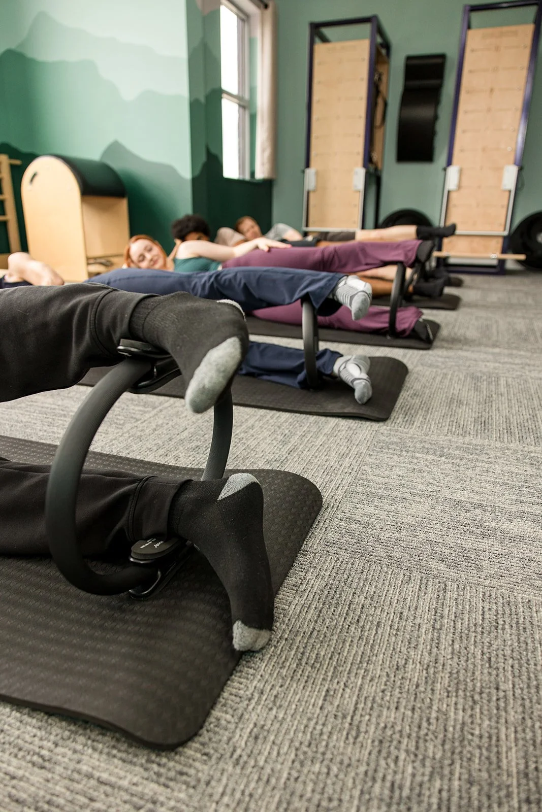 closeup of people's feet on magic circle in a Pilates class