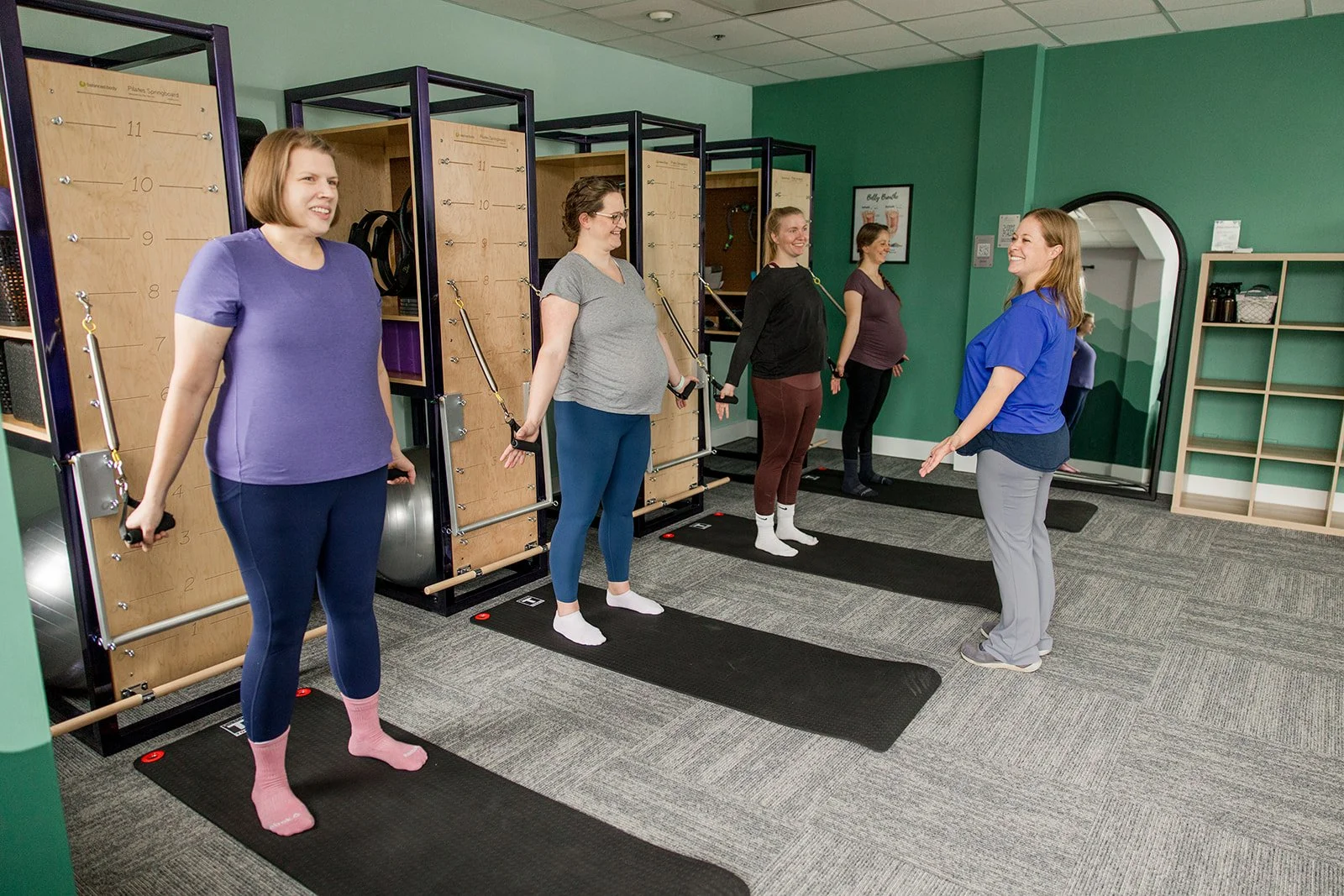 three women in a Pilates tower class