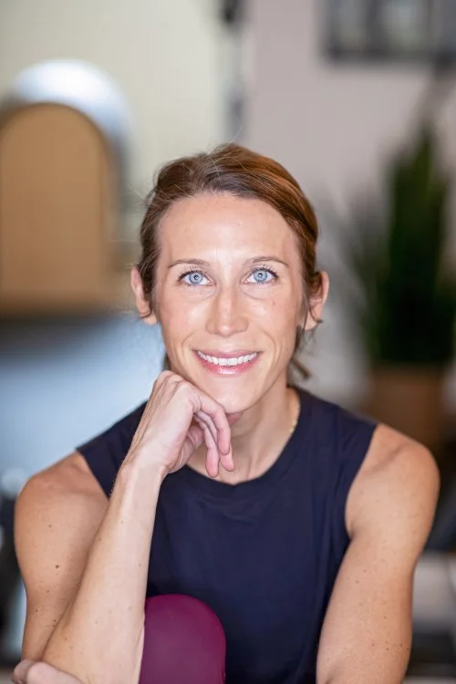 Woman in fitness clothing posing for a headshot