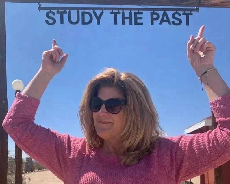 Dr. Anne Wohlcke, historian and writer, is beneath a banner reading 'STUDY THE PAST,' representing her publications on history, astrology, and cultural reflection.