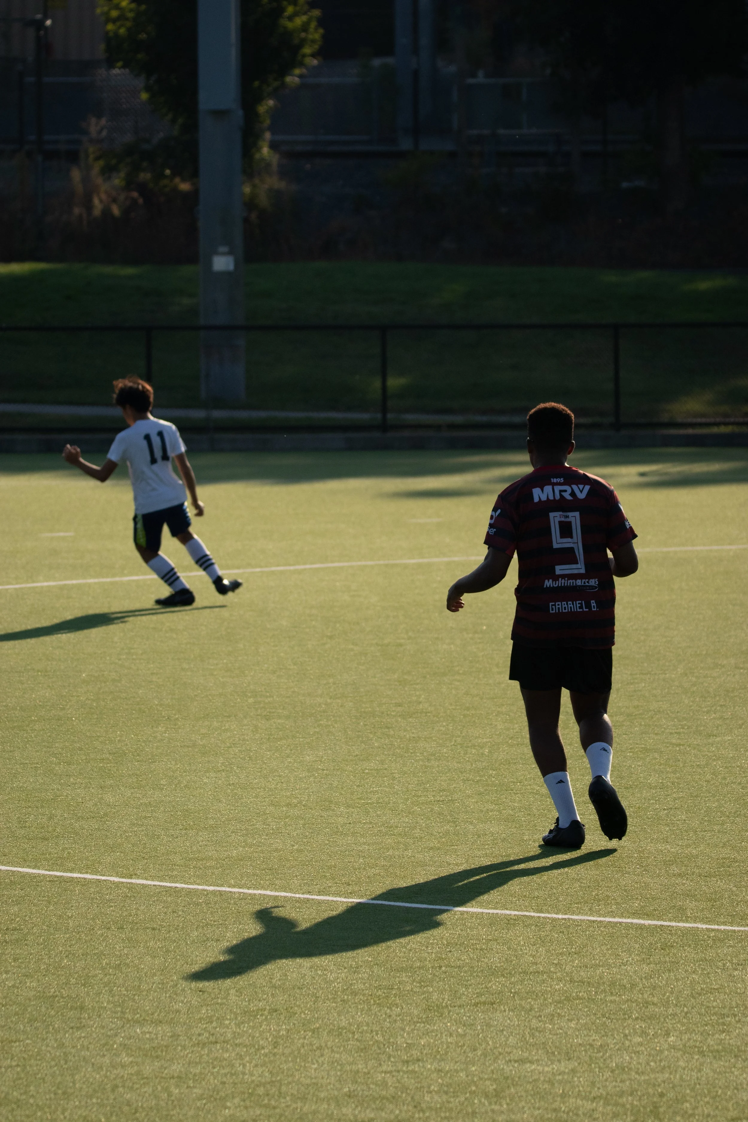 Teens play pickup soccer near Tufts.