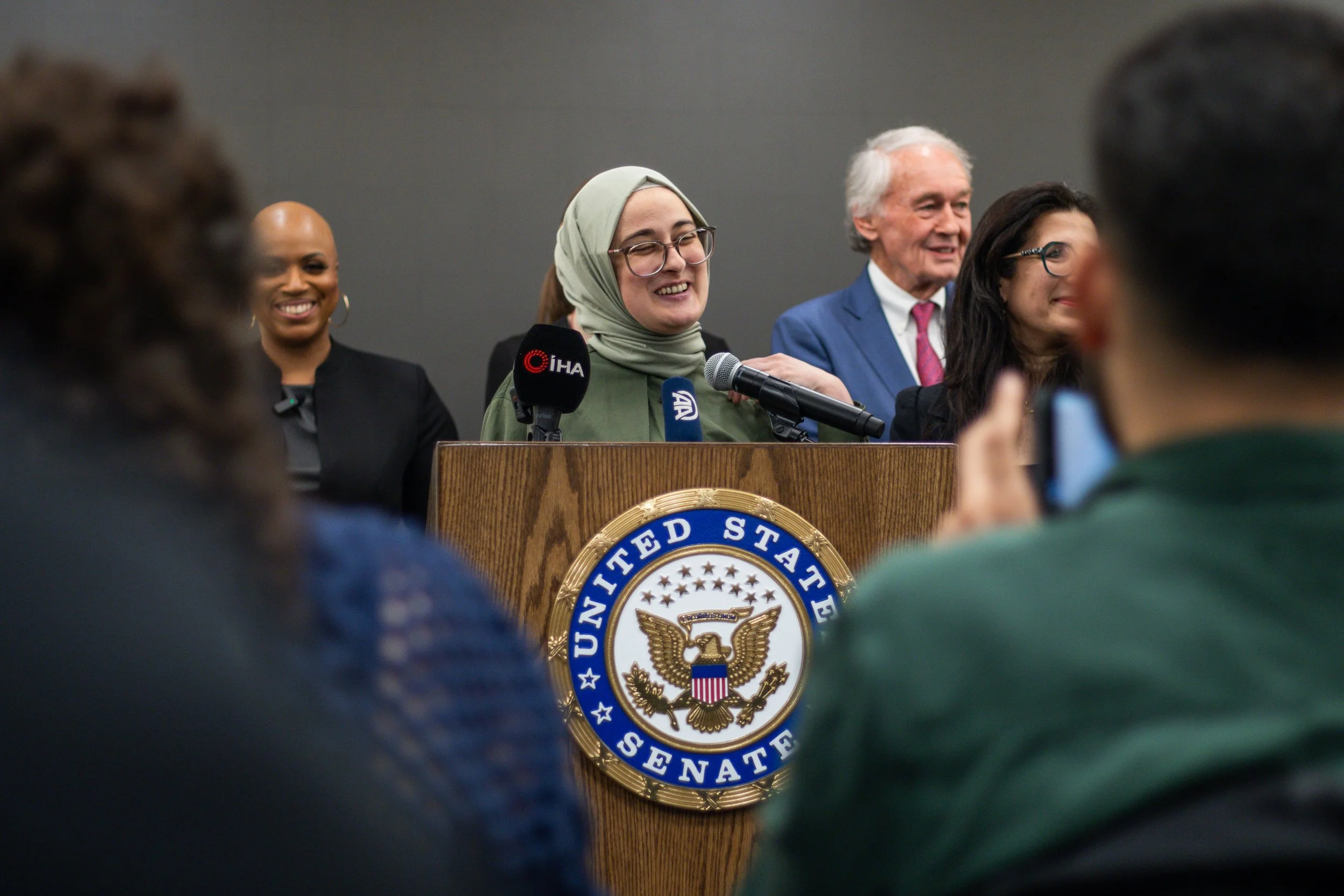 Tufts graduate student Rümeysa Öztürk, detained by federal immigration enforcement in March 2025, speaks at a press conference at Boston Logan International Airport.