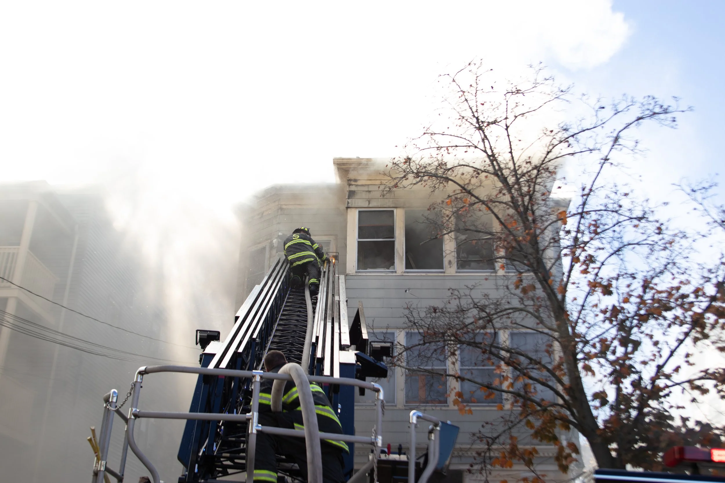Firefighters contain a house fire which had previously engulfed Tufts student housing.